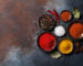 Colorful spices on stone table. Top view with space for your recipe